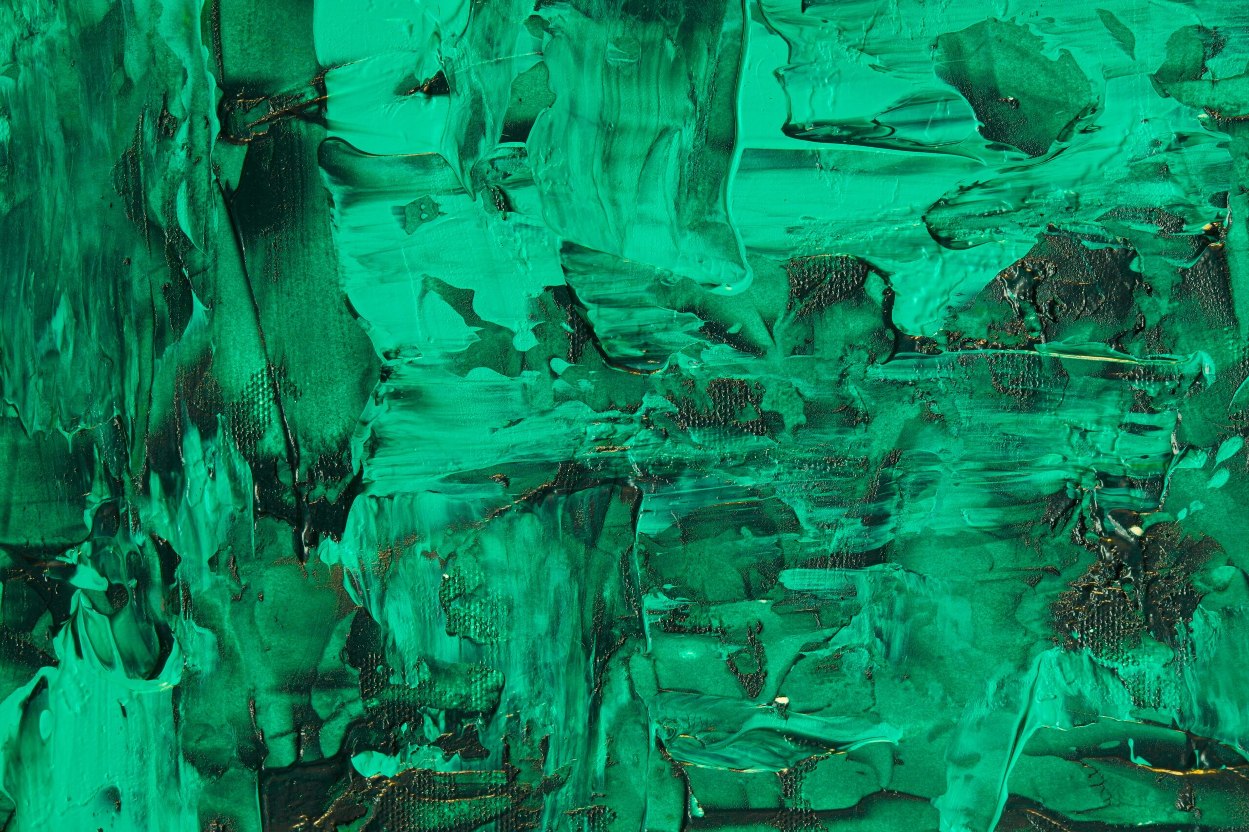 Close-up of a textured emerald green abstract acrylic painting showcasing dynamic brushstrokes.